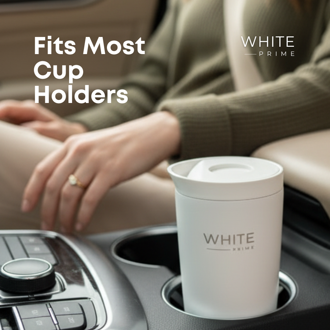 WHITE Prime insulated coffee mug placed in a car cup holder